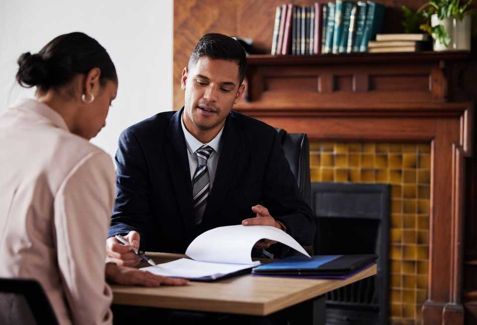 lawyer going over purchase agreement with a client