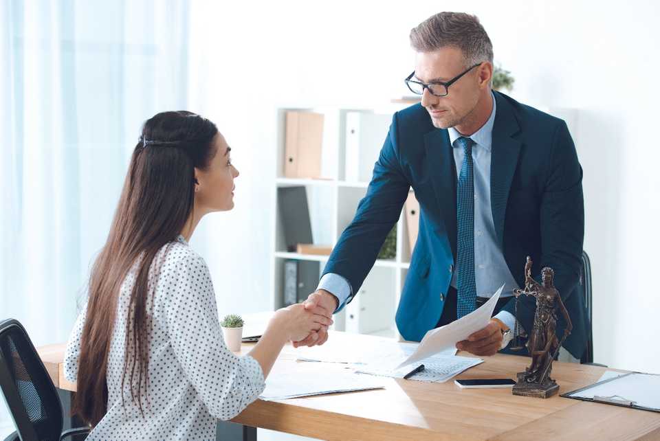 Female consulting a lawyer regarding workplace harassment