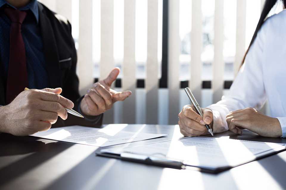 An image containing a table, a person, an interior, a man