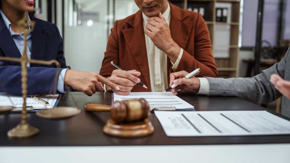 lawyer guiding a client with a settlement offer